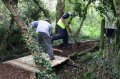 Spreading mulch onto the new desire path bridge
