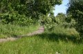 Path leads from picnic bench to steps up to railway line