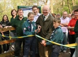 Cllr David Munro cuts the ribbon with local scouts